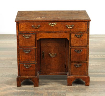Lot 1335 - A GEORGE I FIGURED WALNUT KNEEHOLE DESK