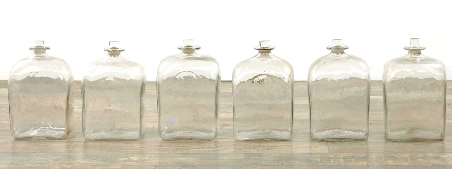 Lot 22 - A SET OF SIX GEORGIAN CLEAR GLASS BOTTLES