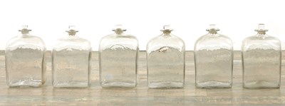 Lot 22 - A SET OF SIX GEORGIAN CLEAR GLASS BOTTLES