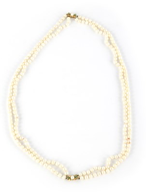Lot 556 - A PAIR OF CULTURED PEARL NECKLACES WITH 14CT GOLD AND EMERALD CLASPS