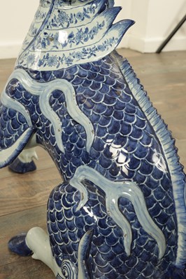 Lot 43 - A PAIR OF DELFT BLUE AND WHITE PORCELAIN MYTHICAL QILINS