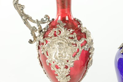 Lot 16 - TWO LATE 19TH CENTURY GLASS AND SILVER PLATED CLARET JUGS