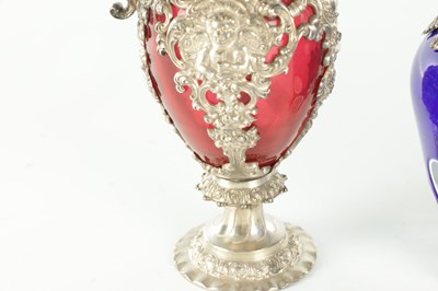 Lot 16 - TWO LATE 19TH CENTURY GLASS AND SILVER PLATED CLARET JUGS