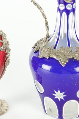 Lot 16 - TWO LATE 19TH CENTURY GLASS AND SILVER PLATED CLARET JUGS