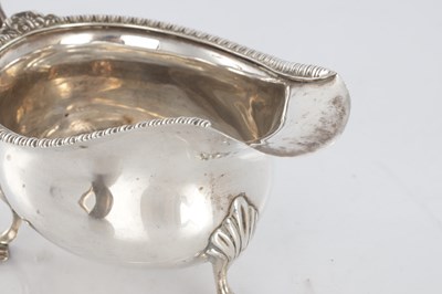 Lot 187 - A GEORGIAN SILVER SAUCEBOAT AND PLATED LADLE