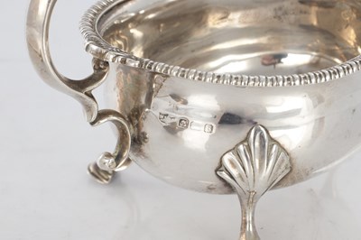 Lot 187 - A GEORGIAN SILVER SAUCEBOAT AND PLATED LADLE