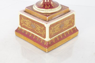 Lot 78 - A 19TH CENTURY VIENNA PORCELAIN TWO HANDLED LIDDED URN SHAPED VASE ON PEDESTAL