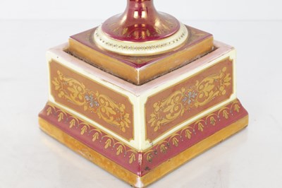 Lot 78 - A 19TH CENTURY VIENNA PORCELAIN TWO HANDLED LIDDED URN SHAPED VASE ON PEDESTAL