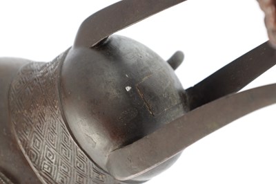 Lot 470 - AN EARLY CHINESE ARCHAISTIC BRONZE TRIPOD VESSEL