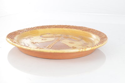 Lot 38 - A 17TH CENTURY STYLE STAFFORDSHIRE SLIP GLAZED TOFTWARE CHARGER