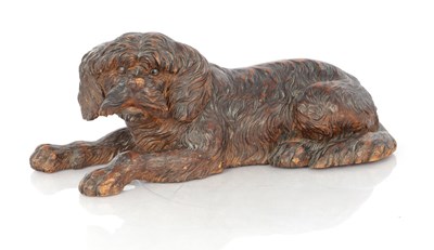 Lot 981 - AN UNUSUAL 19TH CENTURY CARVED LINDEN WOOD BLACK FOREST SCULPTURE OF A RECUMBENT DOG