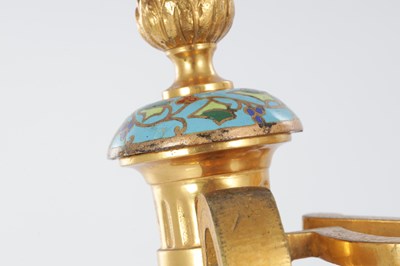 Lot 681 - A PAIR OF LATE 19TH CENTURY FRENCH ORMOLU AND CHAMPLEVE ENAMELLED FIRE DOGS