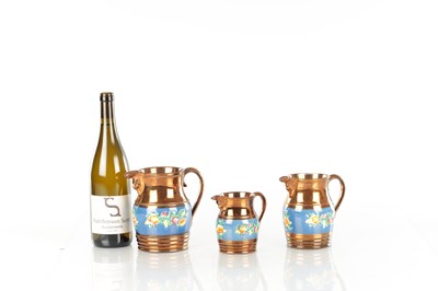 Lot 41 - A GRADUATED SET OF THREE 19TH CENTURY COPPER LUSTRE WARE MUGS