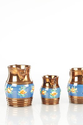 Lot 41 - A GRADUATED SET OF THREE 19TH CENTURY COPPER LUSTRE WARE MUGS
