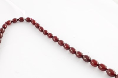 Lot 172 - A GRADUATED CHERRY AMBER OVAL BEAD NECKLACE