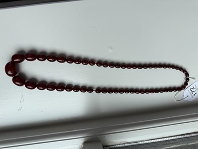 Lot 172 - A GRADUATED CHERRY AMBER OVAL BEAD NECKLACE