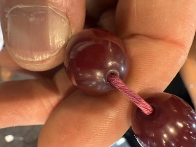 Lot 172 - A GRADUATED CHERRY AMBER OVAL BEAD NECKLACE