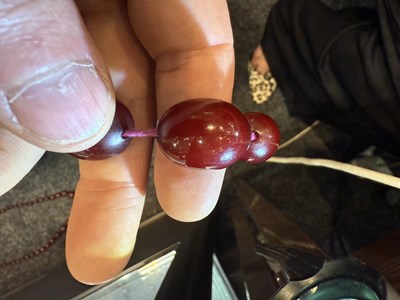 Lot 172 - A GRADUATED CHERRY AMBER OVAL BEAD NECKLACE