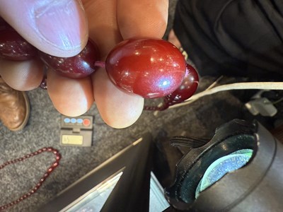Lot 172 - A GRADUATED CHERRY AMBER OVAL BEAD NECKLACE