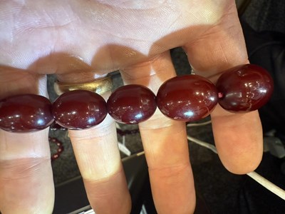 Lot 172 - A GRADUATED CHERRY AMBER OVAL BEAD NECKLACE