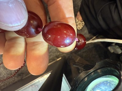 Lot 172 - A GRADUATED CHERRY AMBER OVAL BEAD NECKLACE