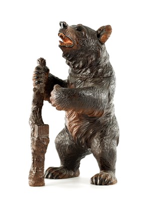 Lot 718 - A LATE 19TH CENTURY BLACK FOREST CARVED BEAR TOBACCO JAR