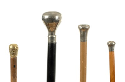 Lot 81 - A COLLECTION OF FOUR EARLY 20TH CENTURY AND SILVER METAL-TOPPED WALKING STICKS