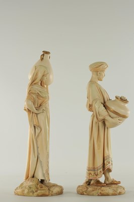 Lot 44 - A PAIR OF LATE 19TH CENTURY ROYAL WORCESTER PORCELAIN FIGURES OF WATER CARRIERS