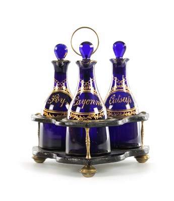 Lot 10 - A SET OF THREE REGENCY COBALT BLUE MINIATURE GLASS DECANTERS AND STAND