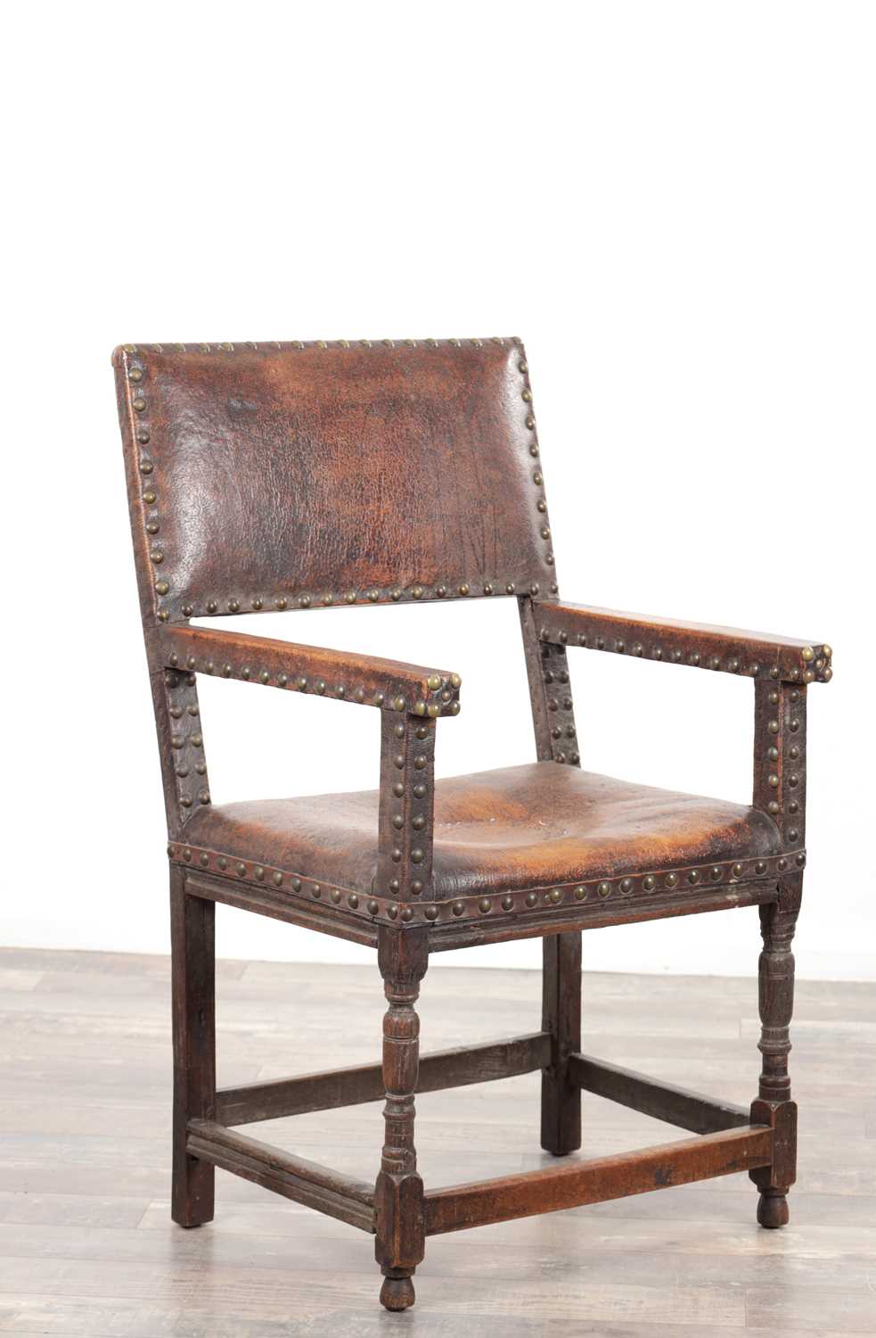 Lot 1580 - A 17TH CENTURY OAK FRAMED LEATHER UPHOLSTERED ARMCHAIR