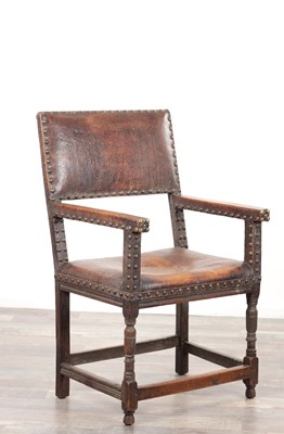 Lot 1661 - A 17TH CENTURY OAK FRAMED LEATHER UPHOLSTERED ARM CHAIR