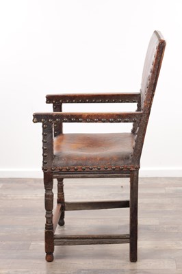 Lot 1580 - A 17TH CENTURY OAK FRAMED LEATHER UPHOLSTERED ARMCHAIR