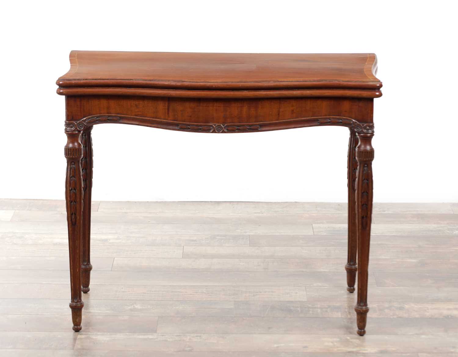Lot 1202 - A GEORGE III SERPENTINE FRONTED CONCERTINA ACTION MAHOGANY CARD TABLE