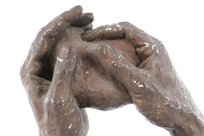 Lot A 20TH CENTURY PLASTER SCULPTURE OF TWO HANDS HOLDING A ROCK
