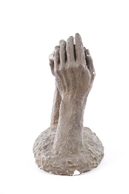 Lot A 20TH CENTURY PLASTER SCULPTURE OF TWO HANDS HOLDING A ROCK