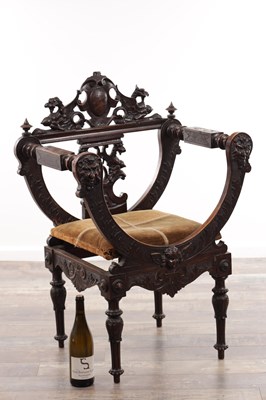 Lot A 19TH CENTURY CARVED WALNUT X FRAMED ARMCHAIR WITH LION MASKS AND GRIFFIN CRESTING