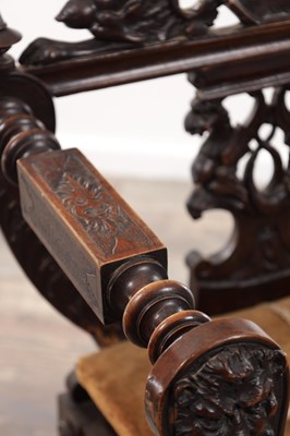 Lot A 19TH CENTURY CARVED WALNUT X FRAMED ARMCHAIR WITH LION MASKS AND GRIFFIN CRESTING
