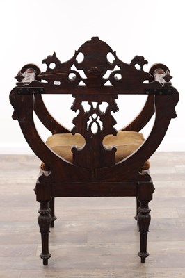 Lot A 19TH CENTURY CARVED WALNUT X FRAMED ARMCHAIR WITH LION MASKS AND GRIFFIN CRESTING