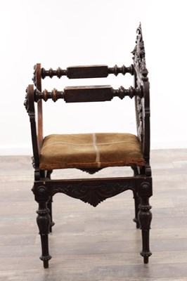 Lot A 19TH CENTURY CARVED WALNUT X FRAMED ARMCHAIR WITH LION MASKS AND GRIFFIN CRESTING