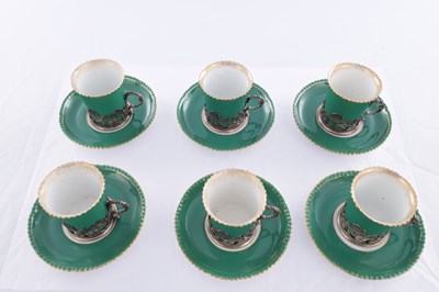 Lot 34 - A SET OF SIX ROYAL WORCESTER CERAMIC AND SILVER MOUNTED CUPS AND SAUCERS