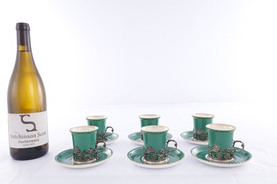 Lot 34 - A SET OF SIX ROYAL WORCESTER CERAMIC AND SILVER MOUNTED CUPS AND SAUCERS