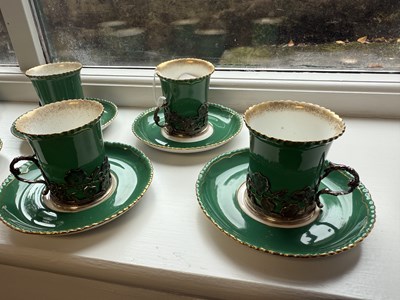 Lot 34 - A SET OF SIX ROYAL WORCESTER CERAMIC AND SILVER MOUNTED CUPS AND SAUCERS