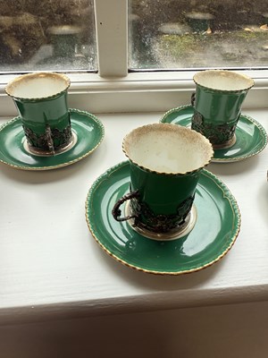 Lot 34 - A SET OF SIX ROYAL WORCESTER CERAMIC AND SILVER MOUNTED CUPS AND SAUCERS