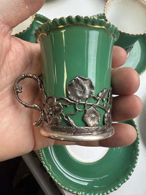 Lot 34 - A SET OF SIX ROYAL WORCESTER CERAMIC AND SILVER MOUNTED CUPS AND SAUCERS