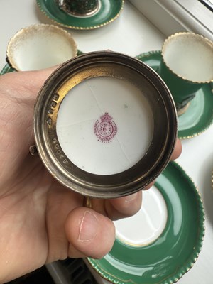 Lot 34 - A SET OF SIX ROYAL WORCESTER CERAMIC AND SILVER MOUNTED CUPS AND SAUCERS