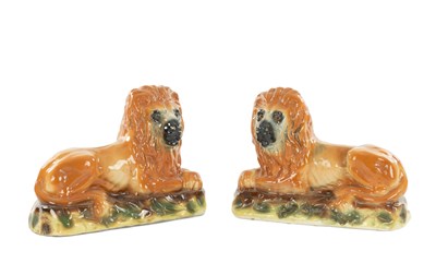 Lot 23 - A PAIR OF 19TH CENTURY SCOTTISH BO'NESS STAFFORDSHIRE POTTERY LIONS