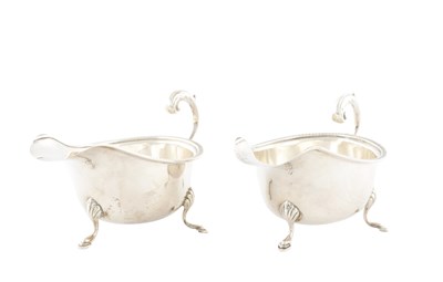 Lot 114 - A PAIR OF MID 20TH CENTURY SILVER CREAM JUGS