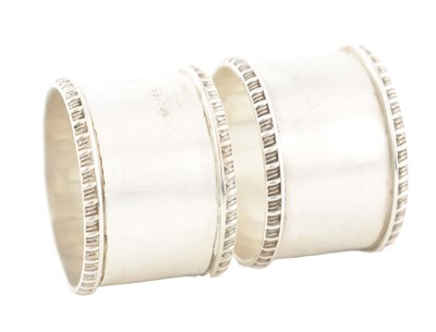 Lot 110 - A SET OF TWO CASED EDWARDIAN SILVER NAPKIN RINGS BY HARRODS