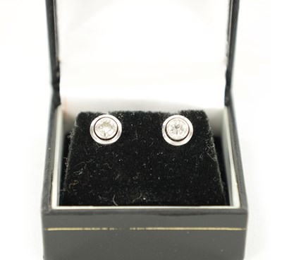 Lot 225 - A PAIR OF LADY'S PLATINUM SOLITAIRE DIAMOND EARRINGS