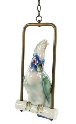 Lot 59 - AN EARLY 20TH CENTURY CONTINENTAL PORCELAIN COCKATOO ON A GILT METAL SWING